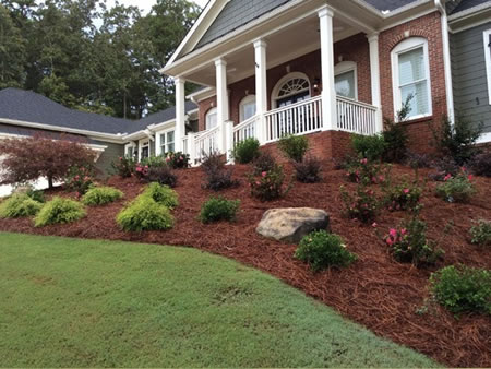 Lawn care crew mowing a bermuda lawn in atlanta neighborhood